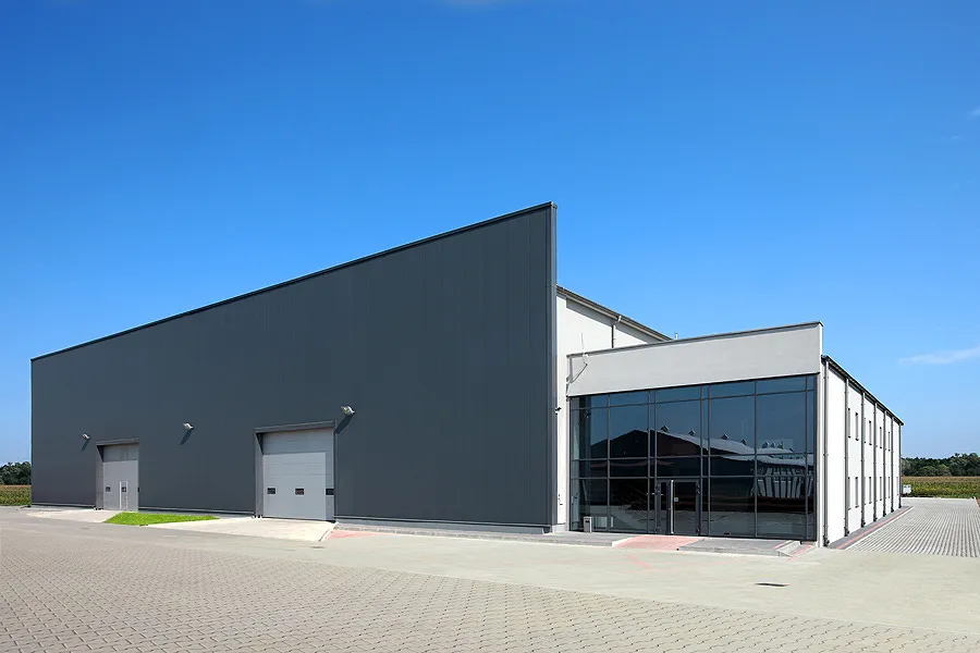 Axces Poland production hall with new warehouse: overhead crane and silencer assemblies on the workshop floor
