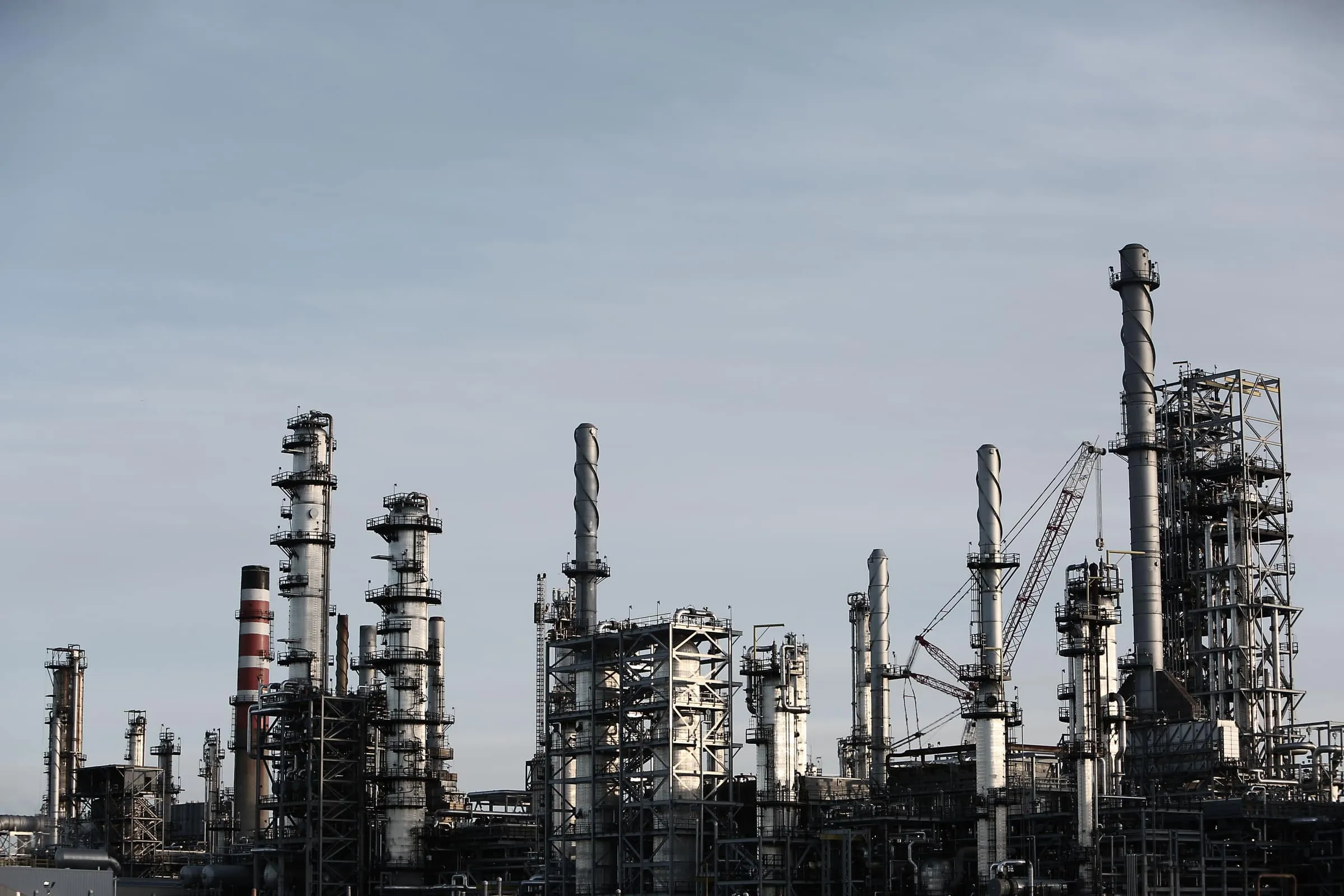 Oil and gas processing facility with flare stacks and pipework, Axces noise, pressure and emission control for hazardous-area installations