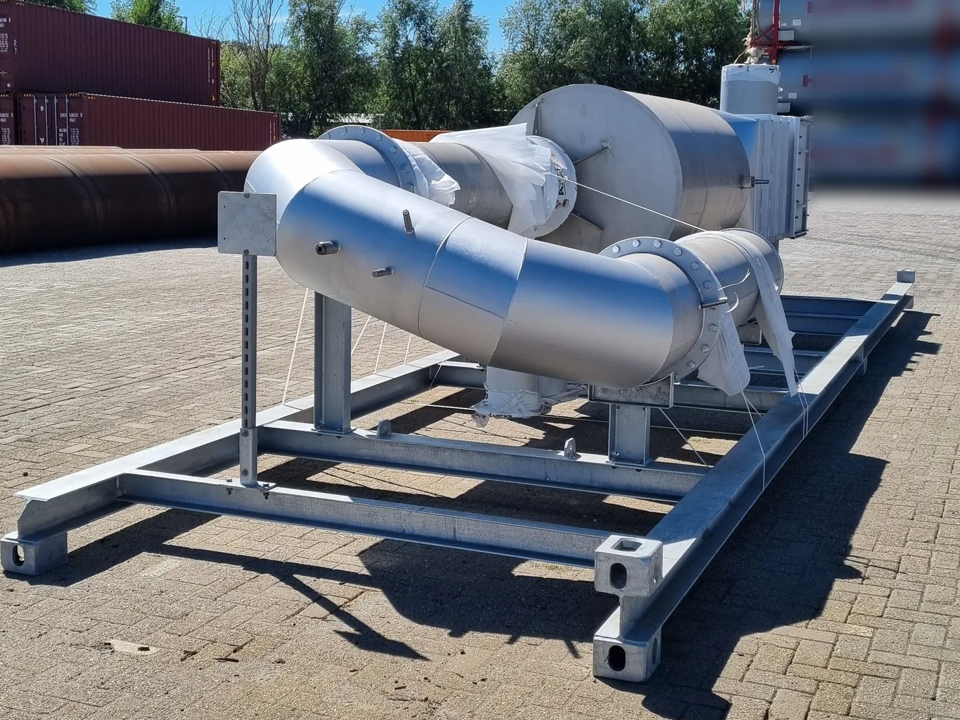 Curved urea mixing pipe leading into the SCR reactor on a galvanised skid frame for a datacenter backup genset
